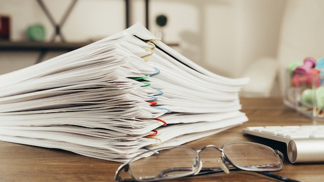 papers held together with multi-colored paper clips